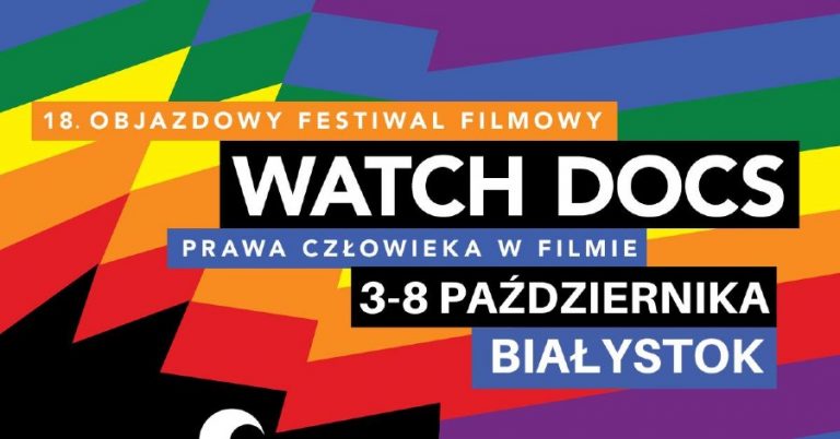 Na fioletowo - niebiesko -zielono - czerwono - żółto- pomarańczowym tle jest napisane 18. Objazdowy Festiwal Filmowy Watch Docs Prawa Człowieka w Filmie