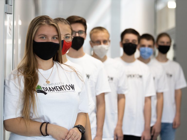 grupa siedmiu uczniów pozuje ubrana w koszulki z napisem Odkrywcy Diamentów
