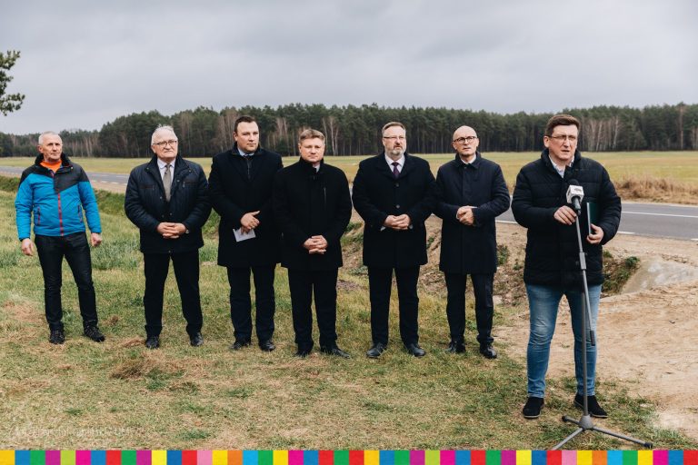 Siedmiu mężczyzn stoi przy drodze
