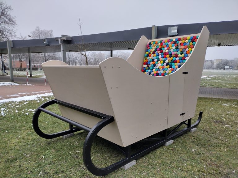 Beżowe sanie w środku, których jest kolorowy materac