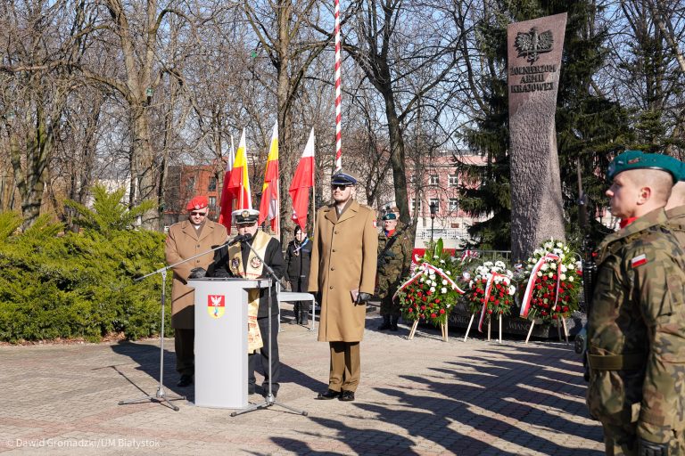 Uroczystosci przy pomniku, obok pomnika stoją żołnierze
