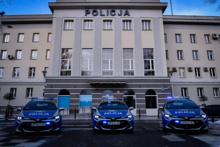 Komenda Wojewódzka Policji w Białymstoku ściana frontowa, przed budynkiem stoją trzy samochody policyjne osobowe